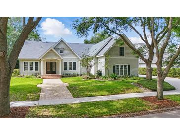 Beautiful suburban home with landscaped front yard and brick walkway at 6241 Blakeford Dr, Windermere, FL 34786