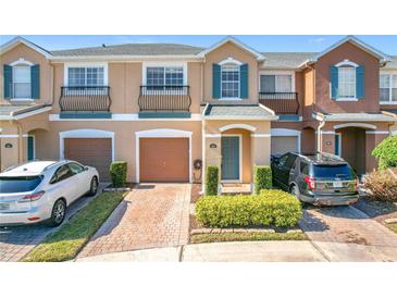 Two-story townhome with attached garage and landscaped front yard at 812 Park Grove Ct, Orlando, FL 32828