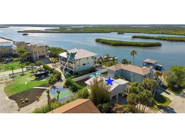 Aerial view of waterfront home with private dock and boat lift at 830 Garfish Ave, New Smyrna Beach, FL 32169