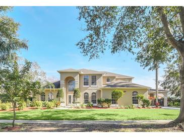 Two-story house with a landscaped lawn and driveway at 10125 Foxhurst Ct, Orlando, FL 32836