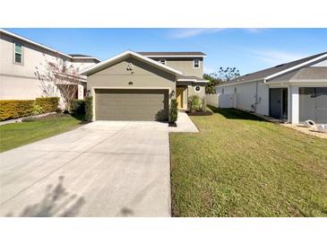 Two-story house with attached garage and landscaped lawn at 1162 Atlantic Ave, Fruitland Park, FL 34731