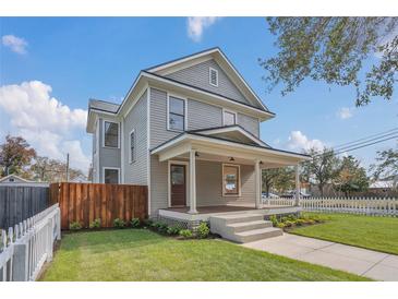 Two-story craftsman home with a wrap-around porch and fenced yard at 219 Laurel Ave, Sanford, FL 32771