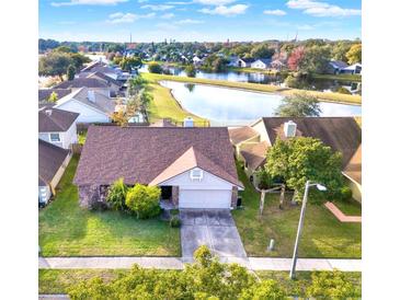Aerial view of a single-Gathering home with a lake view in a residential neighborhood at 388 Westwind Ct, Lake Mary, FL 32746