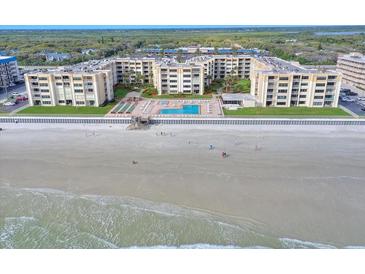 Aerial view of beachfront condo building with pool and ocean views at 4175 S Atlantic Ave # 4070, New Smyrna Beach, FL 32169