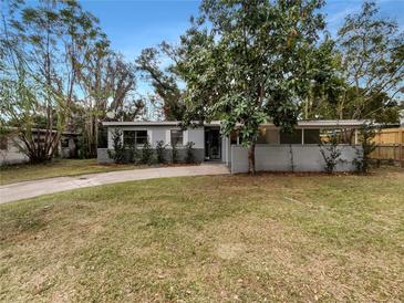 Updated home with a landscaped lawn and driveway at 6117 Oakcrest Cir, Orlando, FL 32808