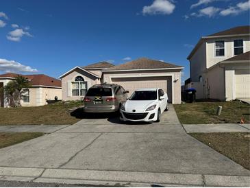 Two-car driveway and a charming house with a well-maintained lawn at 6868 Westlake Blvd, Orlando, FL 32810