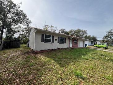 Brick and stucco ranch home with a carport and spacious yard at 990 Liskeard Ave, Orange City, FL 32763