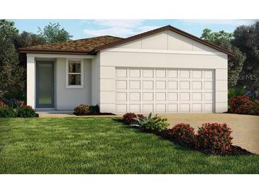 House exterior featuring a two-car garage and well-manicured lawn at 4941 Kaia Ave, Winter Haven, FL 33884