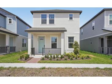 Charming two-story home features a welcoming front porch and well-maintained landscaping at 5087 Railroad Vine Aly, Winter Garden, FL 34787
