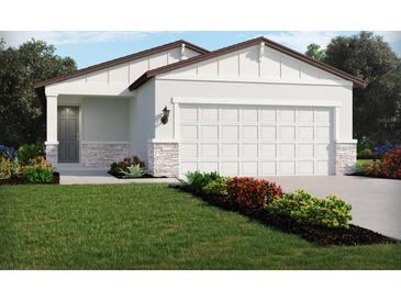 One-story home with stone accents and landscaping at 1373 Current Pl, Haines City, FL 33844