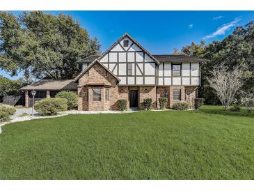 Brick Tudor-style home with a large green lawn at 2540 Albany Dr, Kissimmee, FL 34758