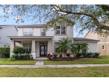 Two-story house with a landscaped lawn and front porch at 2556 Antlia Dr, Orlando, FL 32828