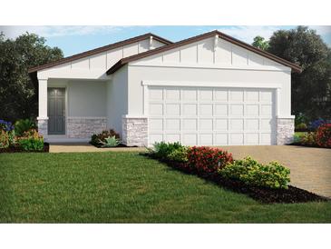 One-story home with two-car garage, landscaping, and stone accents at 3185 Viceroy Ct, Poinciana, FL 34759