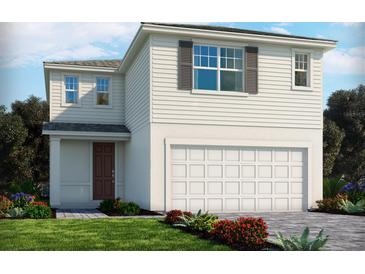 Two-story house with white siding, brown door, and attached garage at 3217 Viceroy Ct, Poinciana, FL 34759