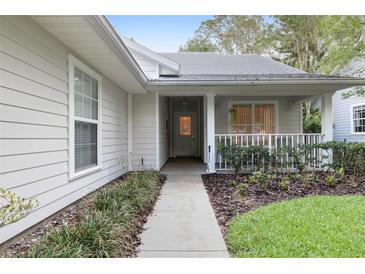 Inviting front porch and walkway leading to the entrance of this charming home at 3315 Newbliss Cir, Ormond Beach, FL 32174