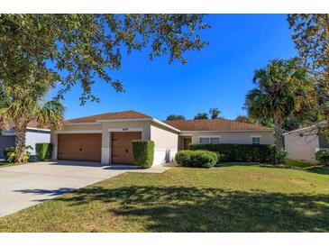 Single-story house with a two-car garage and well-manicured lawn at 4029 Marina Isle Dr, Kissimmee, FL 34746