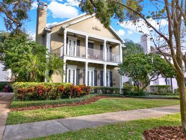 Two-story house with a front porch, landscaping, and walkway at 833 Ellwood Ave, Orlando, FL 32804