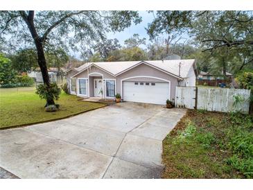 Cute ranch home with a large yard and a two-car garage at 883 Montrose Ave, Orange City, FL 32763