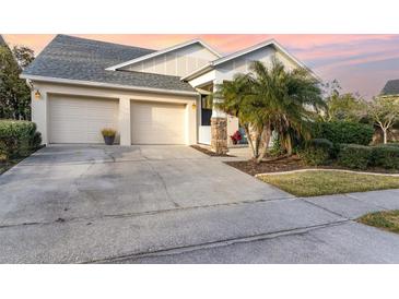 Two-car garage, landscaped yard, and a welcoming porch at 14087 Bradbury Rd, Orlando, FL 32828