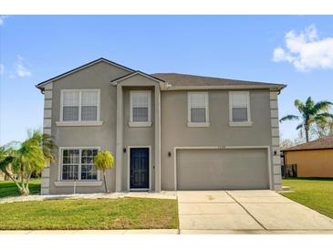 Charming two-story home with landscaped yard and attached two-car garage at 15199 Sugargrove Way, Orlando, FL 32828