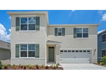 Two-story house with green shutters and a two-car garage at 2970 Salisbury Ave, Haines City, FL 33844