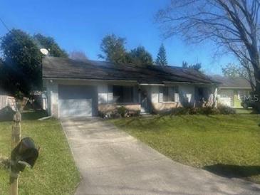 Ranch-style home with attached garage and driveway at 611 Bay Ave, Holly Hill, FL 32117