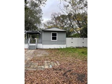 Mobile home exterior with covered porch and fenced yard at 9868 6Th Ave, Orlando, FL 32824