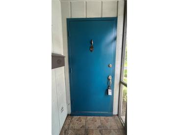 Teal front door entrance with tiled flooring and mailbox at 10 Moree Loop # 1, Winter Springs, FL 32708