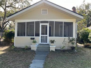 Charming bungalow with a screened porch and well-maintained lawn at 113 W 19Th St, Sanford, FL 32771