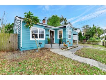 Cute light blue house with a walkway and well-maintained lawn at 1300 E Kaley St, Orlando, FL 32806