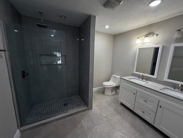 Updated bathroom with double vanity, large shower, and modern fixtures at 359 Prevo Dr, Apopka, FL 32712