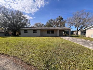 Ranch style home with a well-manicured lawn and driveway at 4706 Kanoy Dr, Lakeland, FL 33805