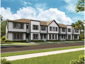 Modern three-story townhouses with white siding and gray trim at 6581 Quest St, St Cloud, FL 34771