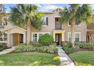 Two-story townhome with attractive landscaping and a welcoming front porch at 8757 Via Tavoleria Way, Windermere, FL 34786