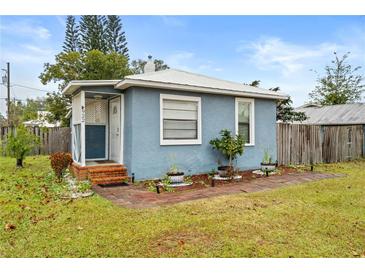 Charming blue house with a landscaped yard and brick walkway at 922 Wyoming Ave, St Cloud, FL 34769