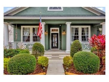 Charming two-story home with a front porch and manicured landscaping at 13055 Lake Live Oak Dr, Orlando, FL 32828