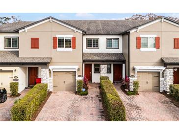 Three-unit townhome building with two-car garages and landscaped front yards at 2909 Econ Landing Blvd, Orlando, FL 32825