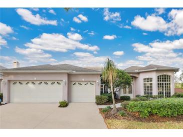 Two-story house with a three-car garage and lush landscaping at 3683 Half Moon Dr, Orlando, FL 32812