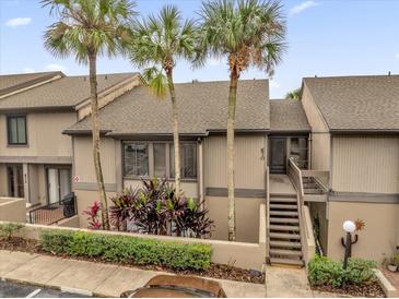 Exterior view of condo building with palm trees and walkway at 670 Lake Villas Dr # D, Altamonte Springs, FL 32701