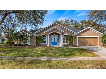 Attractive one-story home with a two-car garage and landscaped lawn at 8835 Spyglass Loop, Clermont, FL 34711