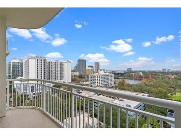 Enjoy breathtaking city views from this spacious balcony with white railings and a clear sky backdrop at 100 S Eola Dr # 1405, Orlando, FL 32801