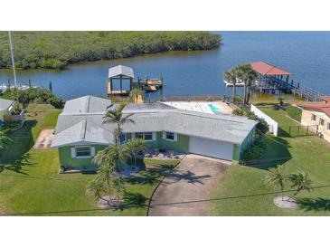 Aerial view of waterfront home with private pool and dock at 218 S Venetian Way, Port Orange, FL 32127