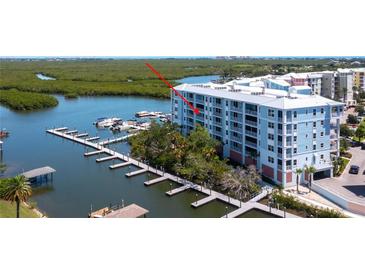 Aerial view of waterfront condo building with boat slips at 3 Riverwalk Dr # 405, New Smyrna Beach, FL 32169