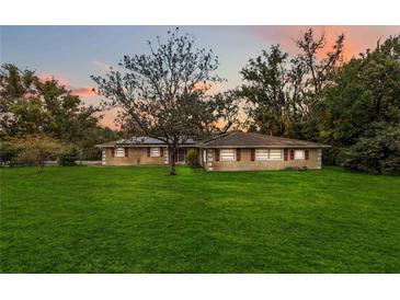 Ranch house with large yard, showcasing a spacious lawn and mature trees at 30845 Westward Ho Ave, Sorrento, FL 32776