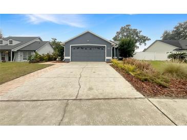 Gray house with a two-car garage and landscaped yard at 311 Silver Pine Dr, Lake Mary, FL 32746