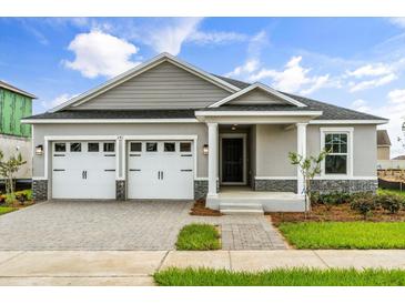 Charming single-story home featuring a two-car garage and a beautifully landscaped front yard at 341 Sunbrooke Dr, Groveland, FL 34736