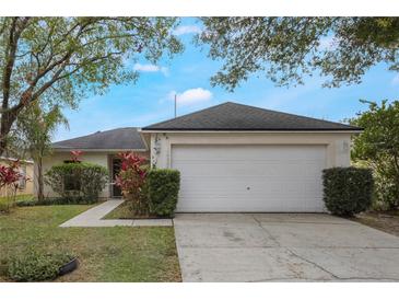 Single-story house with a white garage door and well-maintained lawn at 14528 Lycastle Cir, Orlando, FL 32826