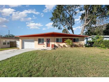 Ranch style home with a red roof and a well-maintained lawn at 716 Katherine St, South Daytona, FL 32119