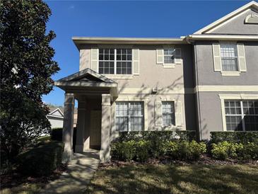 Two-story townhome with neutral siding and landscaping at 8634 Danforth Dr, Windermere, FL 34786