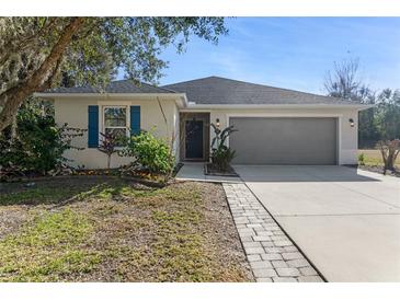 One-story home with gray siding, blue shutters, and landscaped yard at 108 Alexandria Cir, Deland, FL 32724